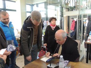 Besnik Mustafaj signs books for readers