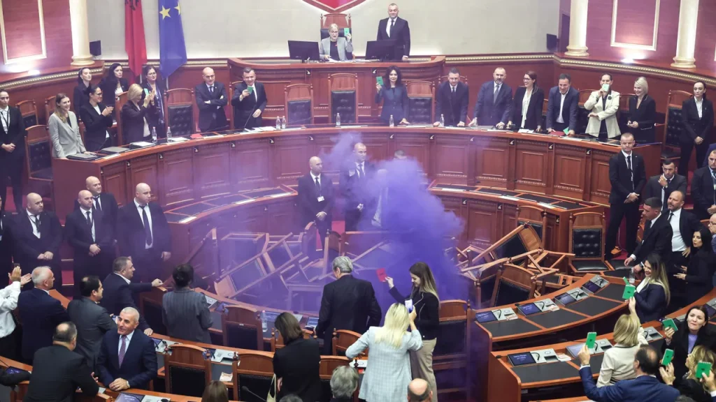 Opposition Democratic Party lawmakers set off flares inside Albania’s parliament in Tirana on Oct. 29, 2026, overturning chairs and filling the chamber with smoke, following weeks of student-led, anti-government protests.